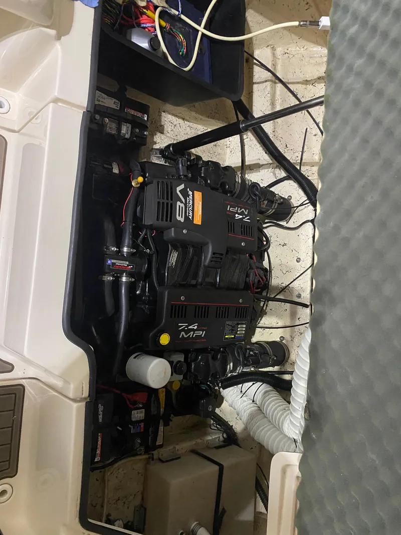 Slide: The Image of Engine compartment of a 2001 Rinker 272 Captiva boat, featuring a V8 engine. - 14