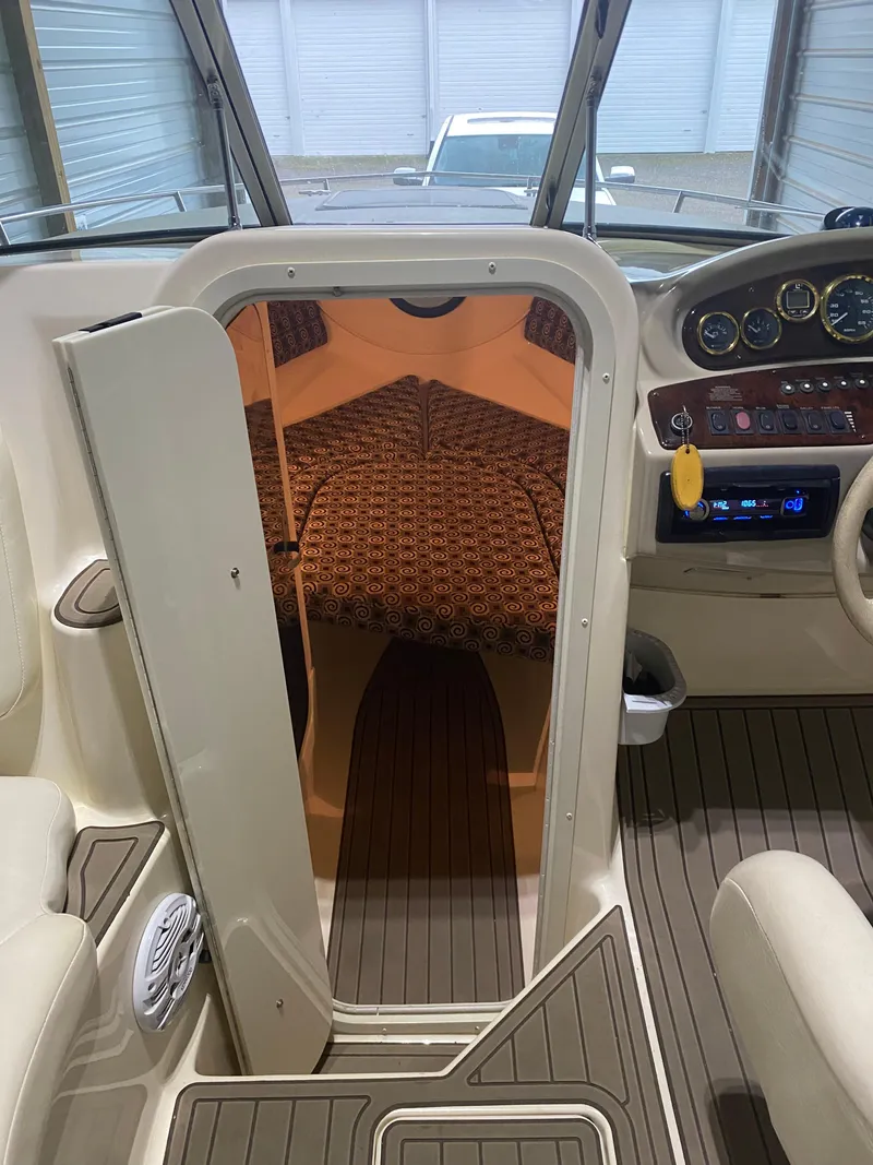 Slide: The Image of 2001 Rinker 272 Captiva boat interior with cabin view and dashboard. - 4