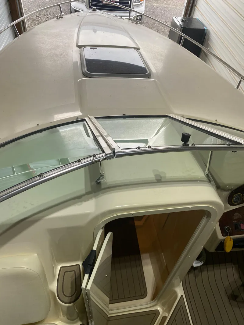 Slide: The Image of 2001 Rinker 272 Captiva boat interior with open cabin door and windshield. - 5