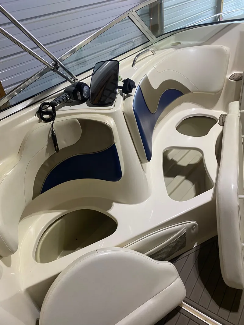 Slide: The Image of 2001 Rinker 272 Captiva boat interior with seating and storage compartments. - 8