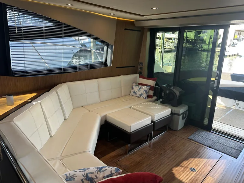 Slide: The Image of Luxurious interior of 2016 Sea Ray L590 Fly yacht with white leather seating and wood flooring. - 19
