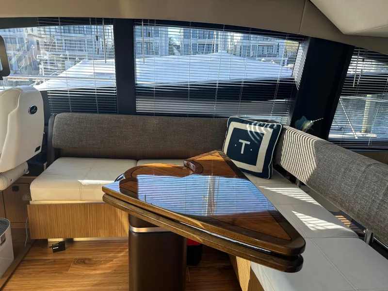 Slide: The Image of Luxurious interior of 2016 Sea Ray L590 Fly yacht with elegant seating and wooden table. - 21