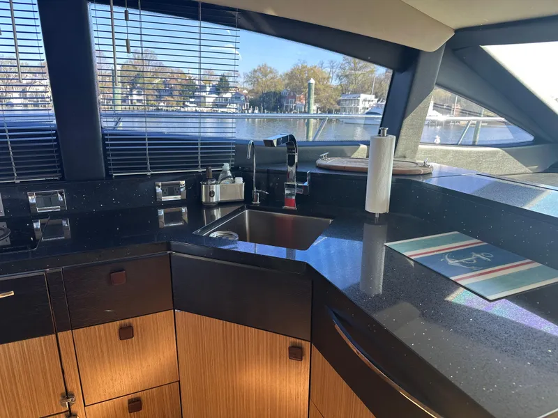 Slide: The Image of Luxurious kitchen interior of 2016 Sea Ray L590 Fly yacht with sleek countertops and modern fixtures. - 23