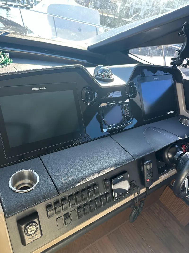 Slide: The Image of 2016 Sea Ray L590 Fly helm with advanced navigation displays and controls. - 25