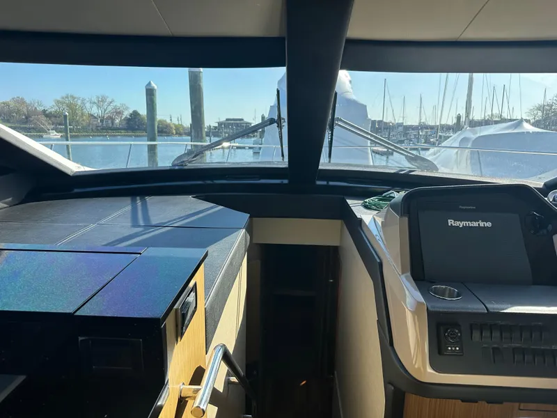 Slide: The Image of Interior view of 2016 Sea Ray L590 Fly yacht cockpit with Raymarine navigation system. - 26