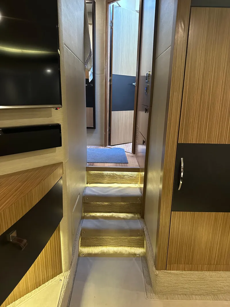 Slide: The Image of Interior view of 2016 Sea Ray L590 Fly yacht, featuring modern wood paneling and sleek design. - 28