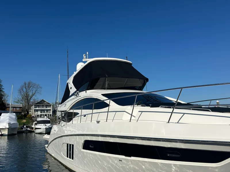Slide: The Image of 2016 Sea Ray L590 Fly yacht docked under clear blue sky. - 3