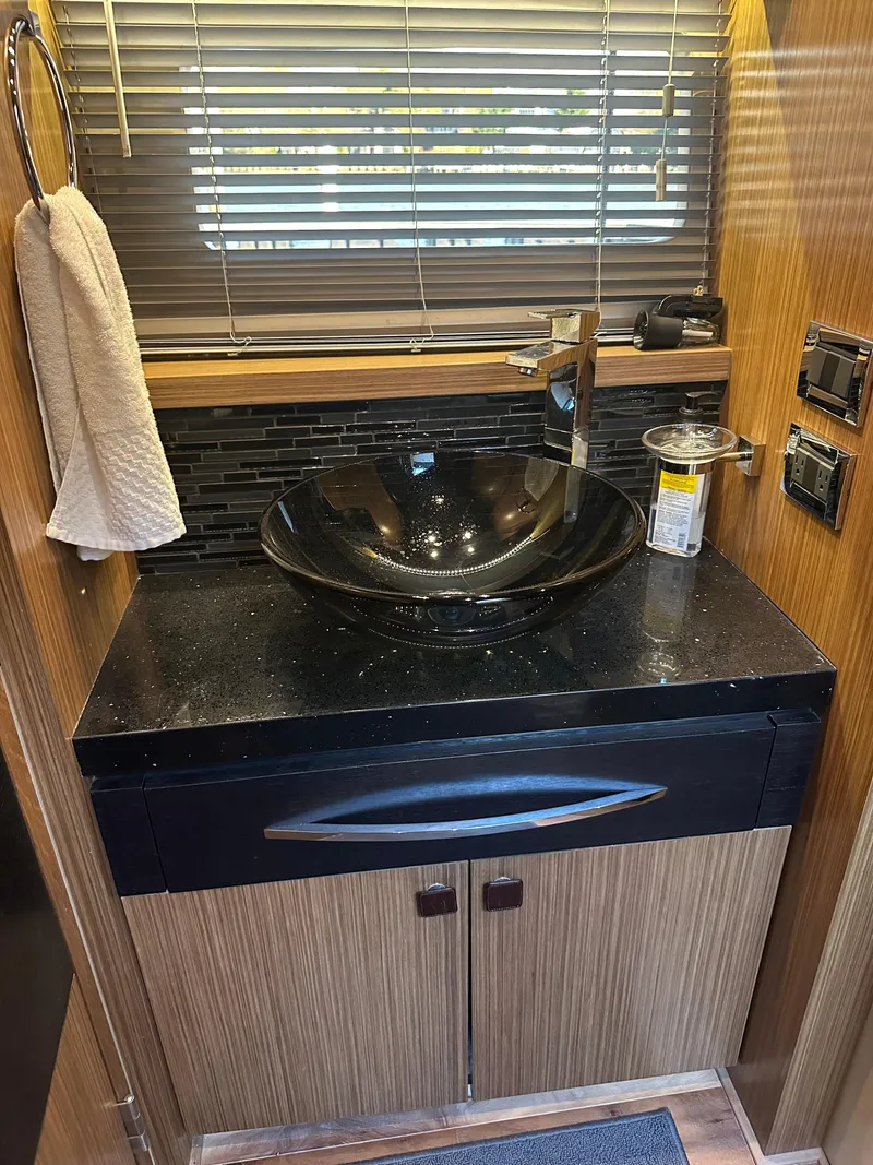 Slide: The Image of Luxurious bathroom sink area in 2016 Sea Ray L590 Fly yacht. - 33