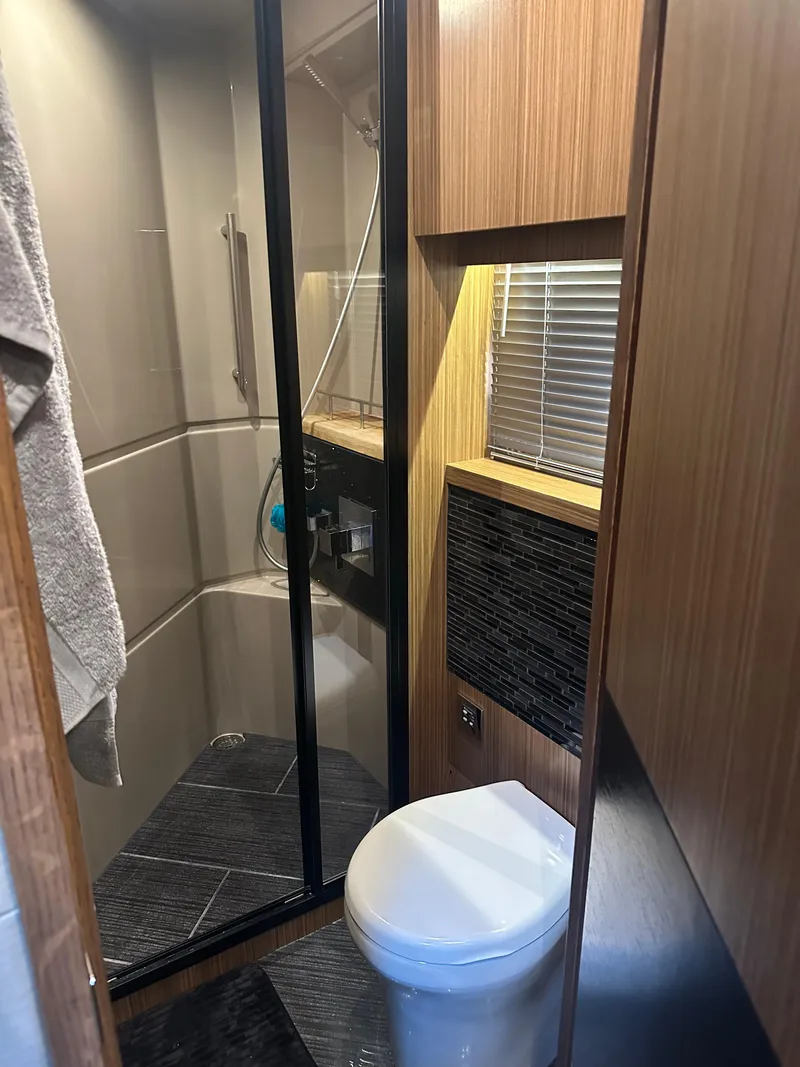 Slide: The Image of 2016 Sea Ray L590 Fly yacht bathroom with modern shower and toilet. - 34