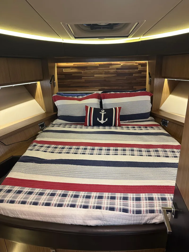 Slide: The Image of Luxurious 2016 Sea Ray L590 Fly yacht bedroom with nautical-themed bedding. - 39