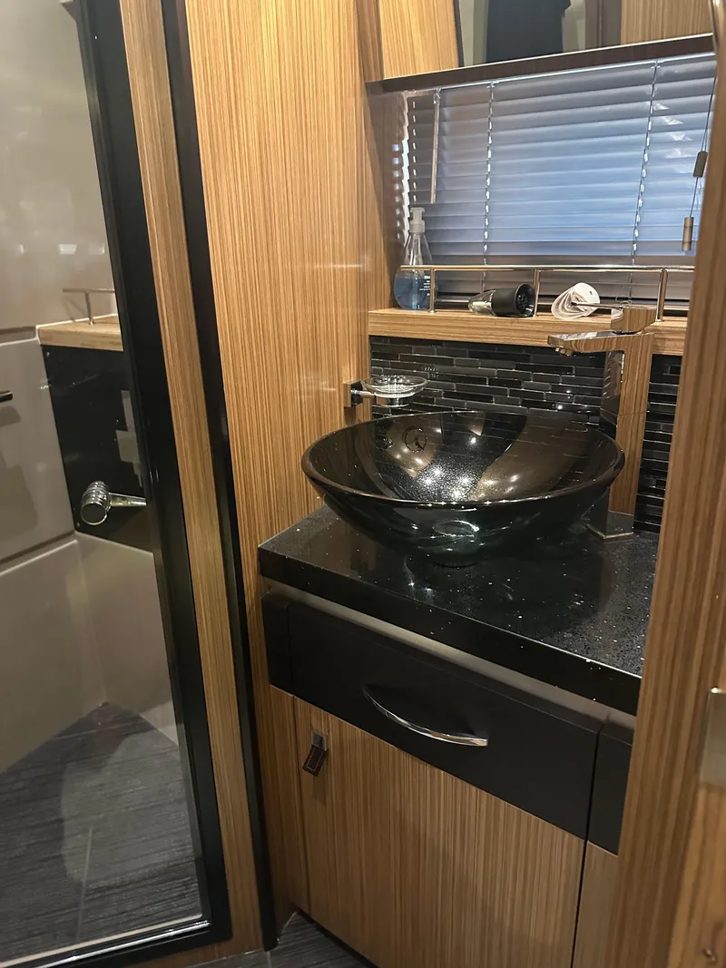 Slide: The Image of Luxurious bathroom in 2016 Sea Ray L590 Fly yacht with modern glass sink. - 40