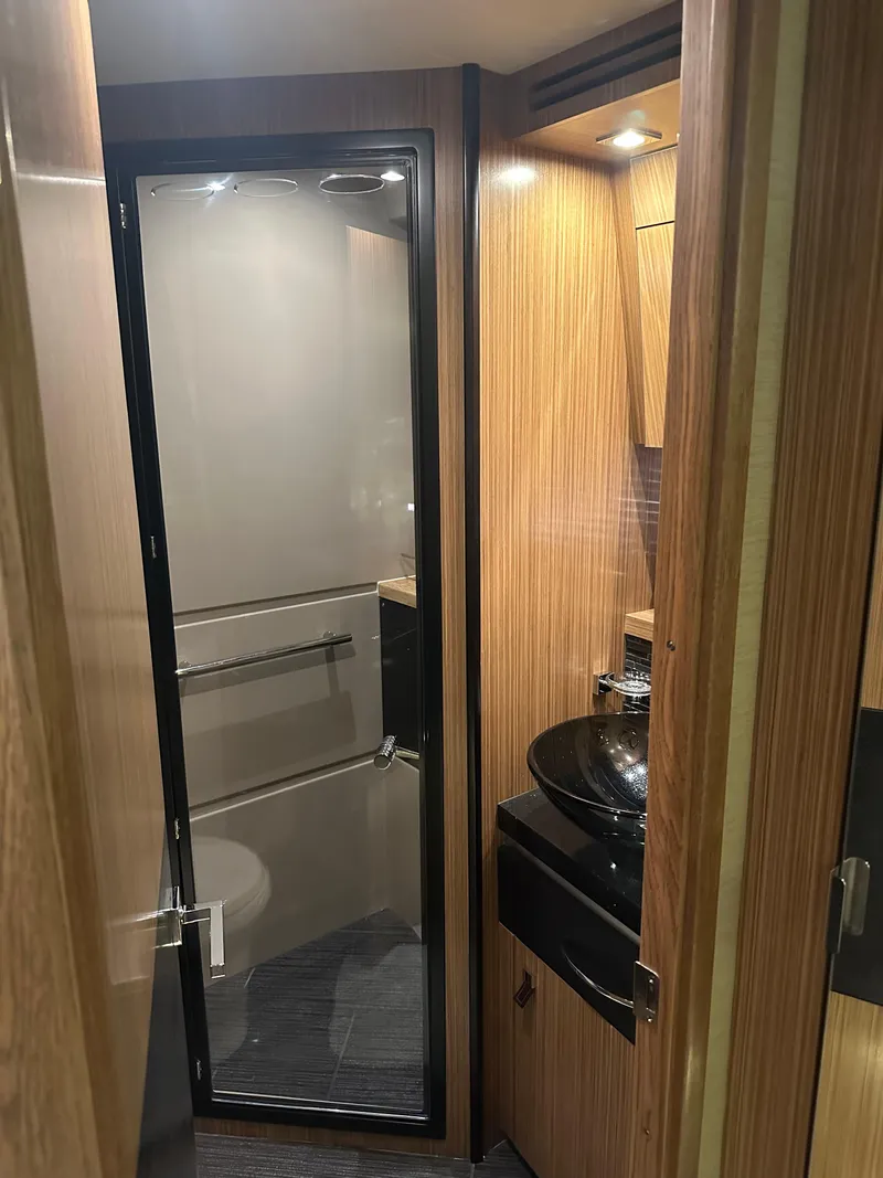 Slide: The Image of 2016 Sea Ray L590 Fly yacht bathroom with glass shower door and modern sink. - 41