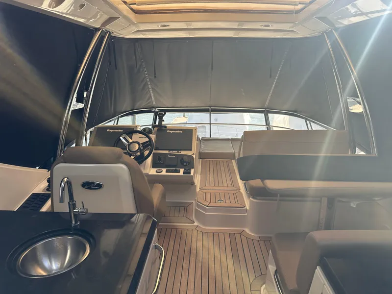 Slide: The Image of Interior of 2016 Sea Ray L590 Fly yacht with modern helm and seating area. - 44