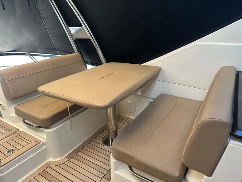 Slide: The Image of 2016 Sea Ray L590 Fly yacht interior with beige seating and table. - 47