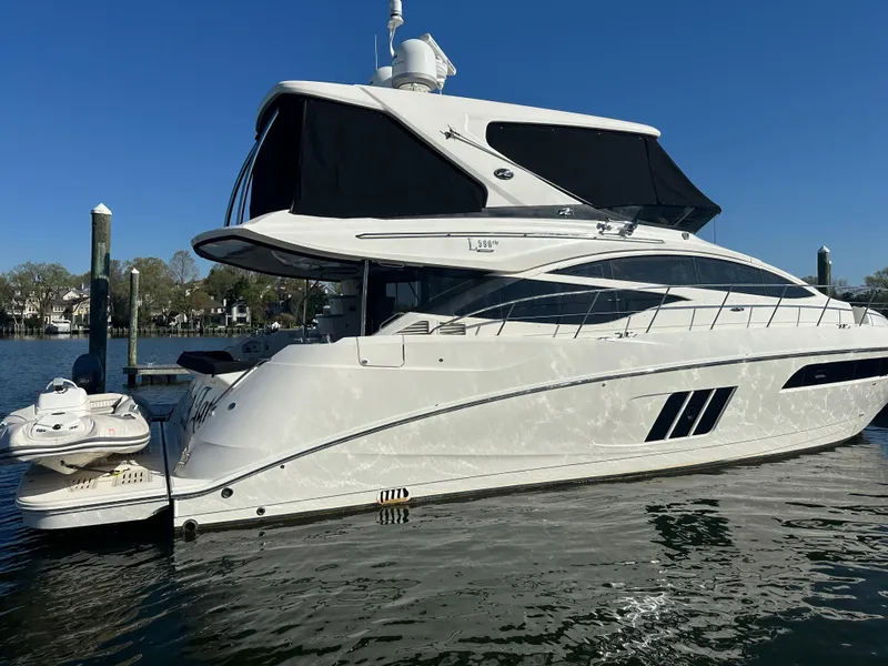 Slide: The Image of 2016 Sea Ray L590 Fly yacht docked on calm water. - 5