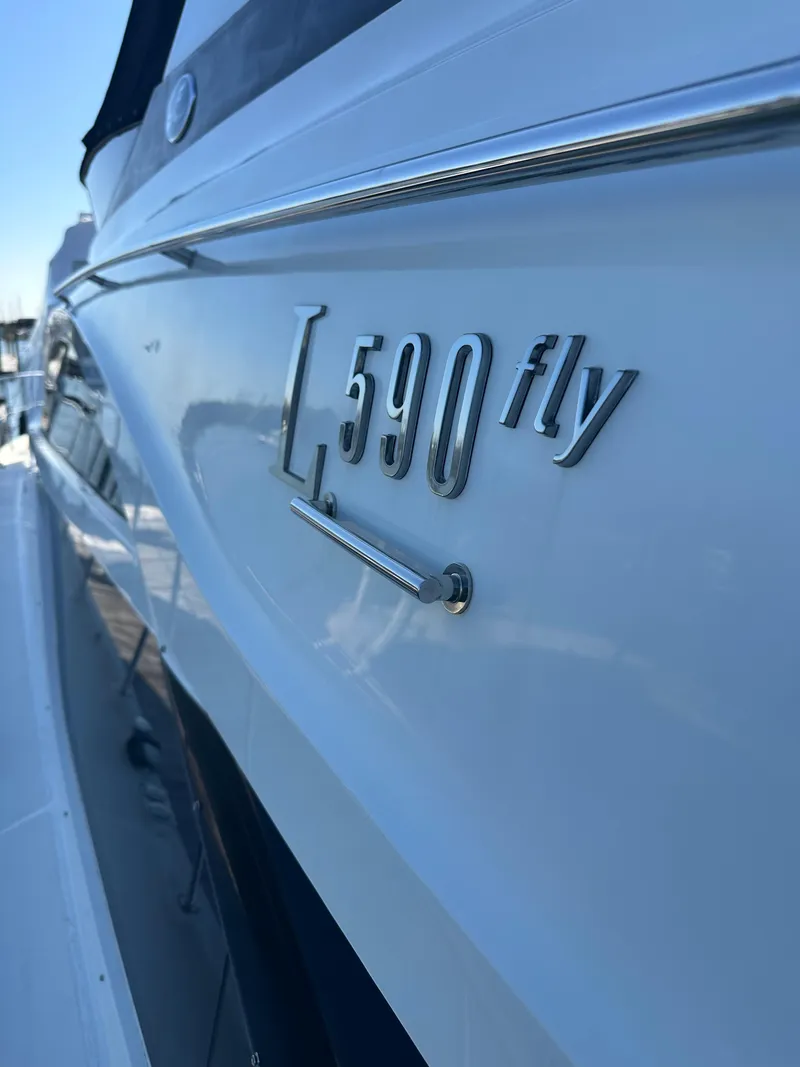 Slide: The Image of 2016 Sea Ray L590 Fly yacht side view with model emblem. - 8
