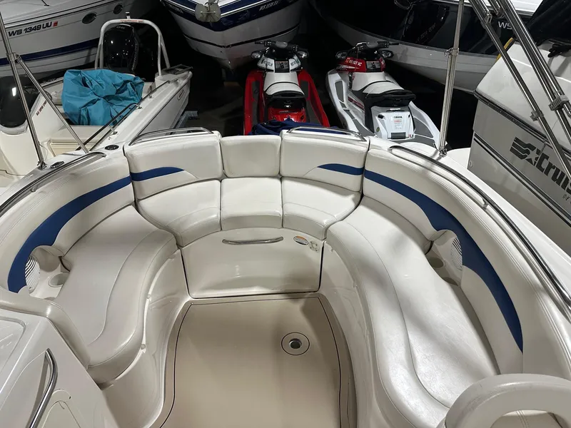 Slide: The Image of 2001 Chaparral Sunesta 263 boat interior with white and blue seating, surrounded by other boats. - 10