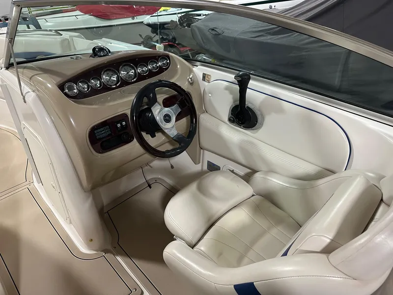 Slide: The Image of 2001 Chaparral Sunesta 263 boat cockpit with steering wheel and control panel. - 11