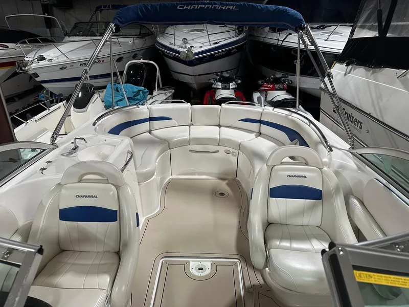 Slide: The Image of 2001 Chaparral Sunesta 263 boat interior with white seating and blue accents. - 14