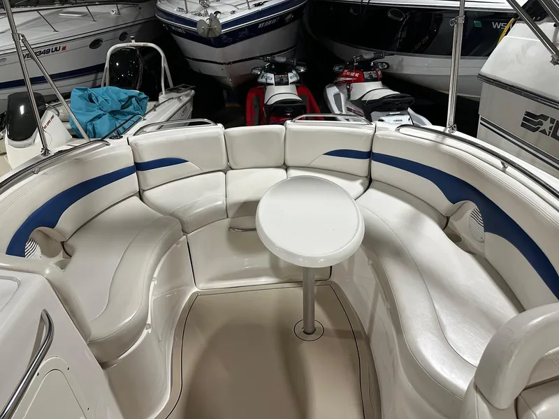 Slide: The Image of 2001 Chaparral Sunesta 263 boat interior with white seating and a central table. - 17