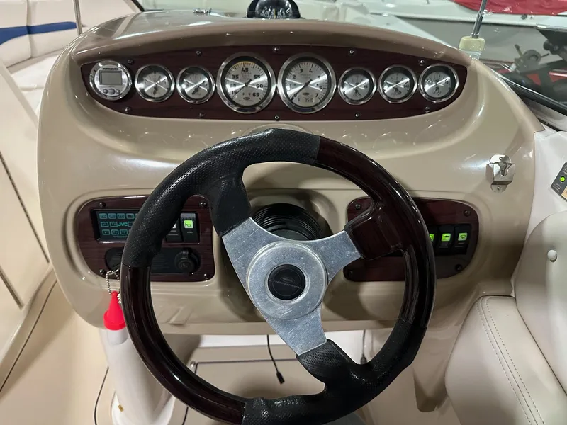 Slide: The Image of Steering console of a 2001 Chaparral Sunesta 263 boat with gauges and controls. - 20