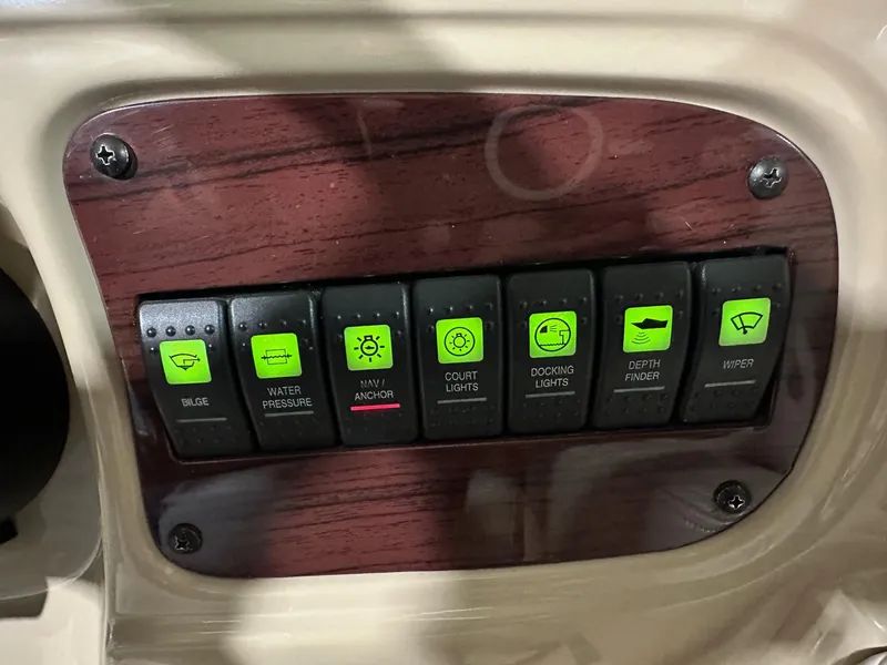 Slide: The Image of Control panel of a 2001 Chaparral Sunesta 263 boat with labeled switches. - 21