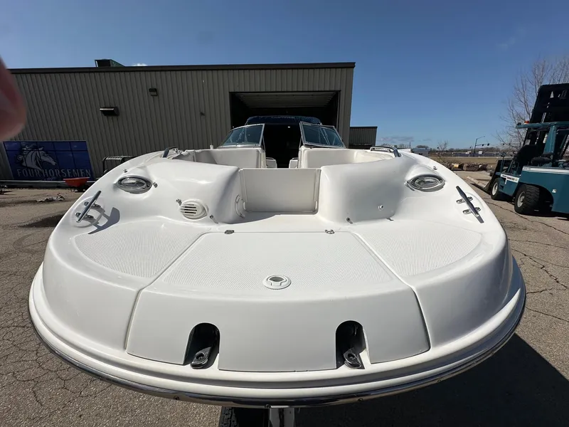 Slide: The Image of 2001 Chaparral Sunesta 263 boat, white deck, parked outdoors near industrial building. - 22