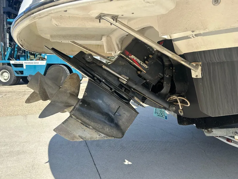 Slide: The Image of 2001 Chaparral Sunesta 263 boat with Mercury outdrive and propeller, docked on concrete. - 24