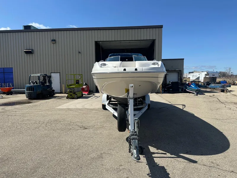 Slide: The Image of 2001 Chaparral Sunesta 263 boat on trailer outside industrial building. - 3