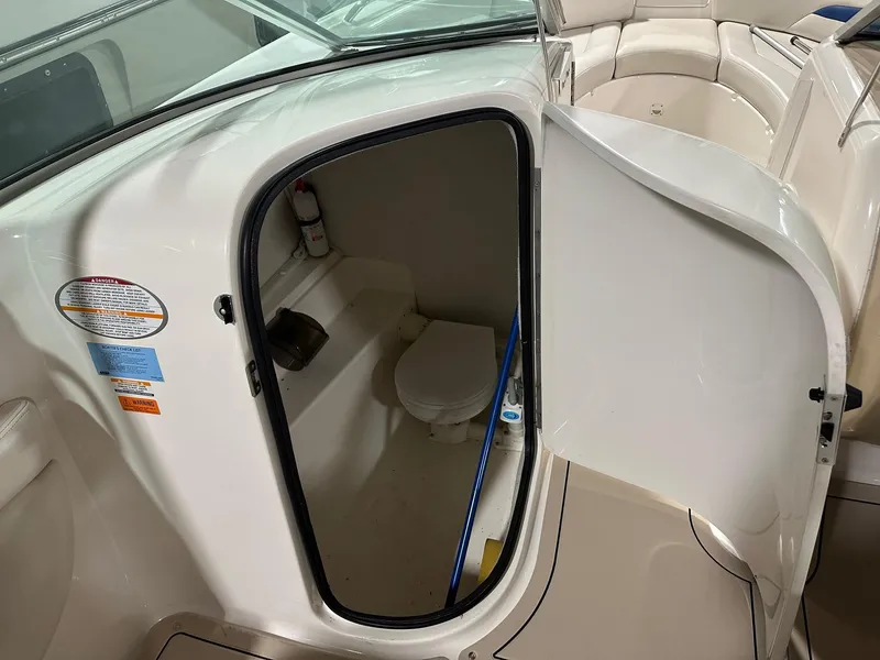 Slide: The Image of 2001 Chaparral Sunesta 263 boat interior with open bathroom door. - 32