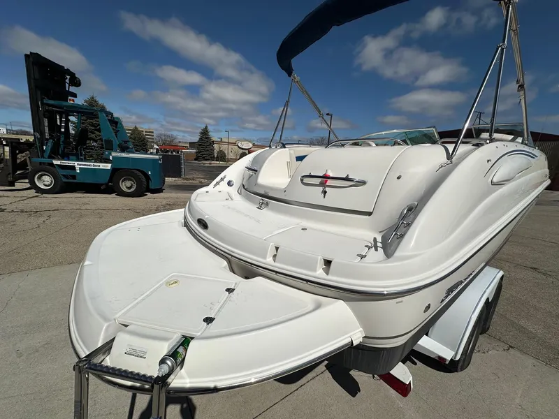 Slide: The Image of 2001 Chaparral Sunesta 263 boat on trailer, sunny day, blue sky, industrial background. - 4