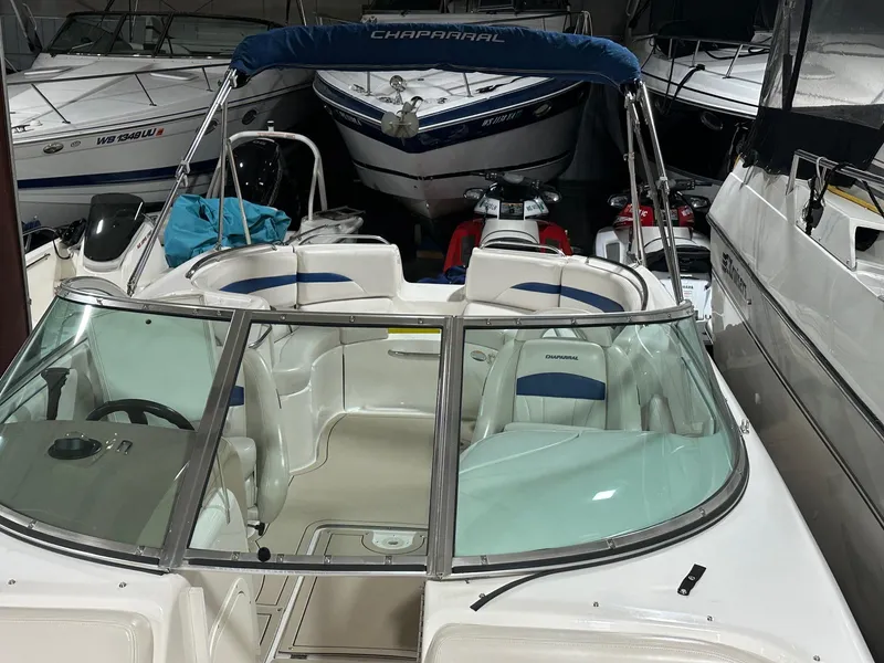 Slide: The Image of 2001 Chaparral Sunesta 263 boat with blue and white interior, stored indoors. - 7