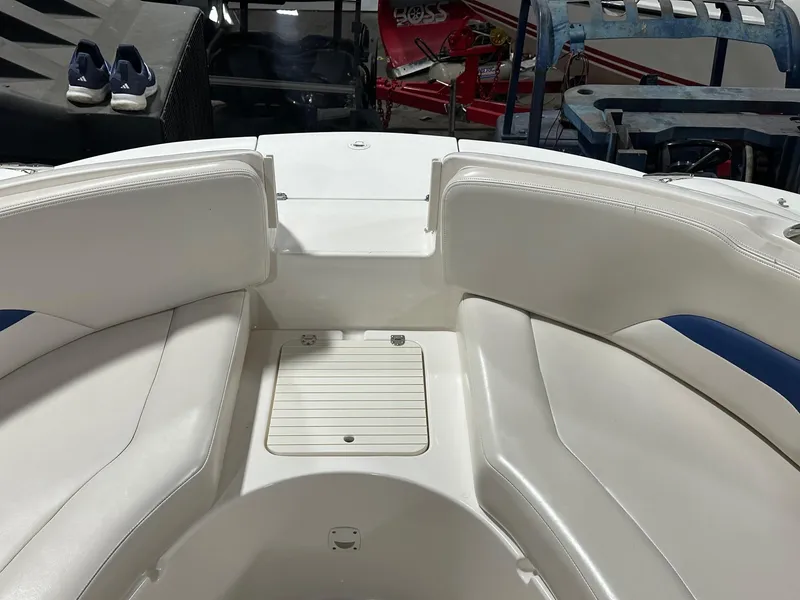 Slide: The Image of 2001 Chaparral Sunesta 263 boat interior with white seating and storage compartment. - 8
