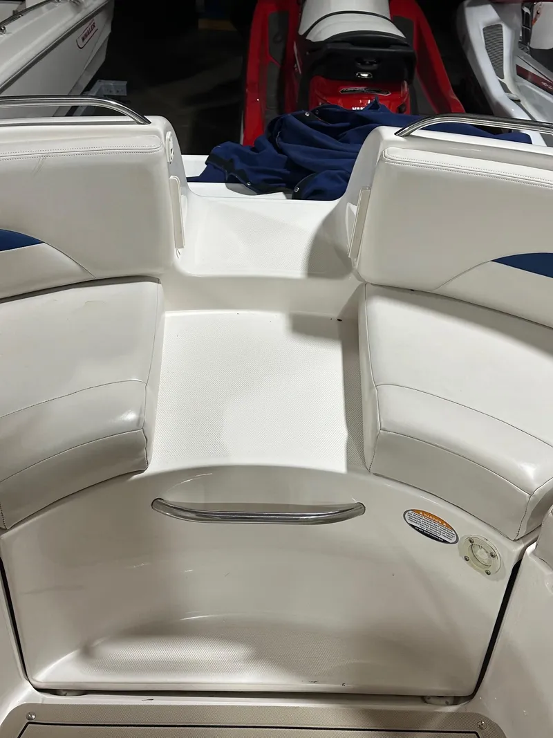 Slide: The Image of 2001 Chaparral Sunesta 263 boat interior with white seating and stainless steel handle. - 9