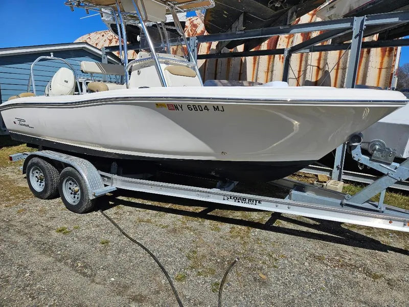 Slide: The Image of 2015 Pioneer Islander 197 boat on trailer, parked outdoors. - 1