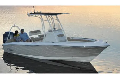 Slide: The Image of 2015 Pioneer Islander 197 boat on calm water at sunset, featuring sleek design and spacious seating. - 16