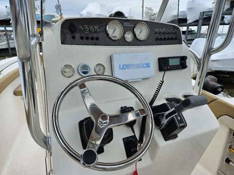 Slide: The Image of Steering console of a 2015 Pioneer Islander 197 boat with gauges and controls. - 17