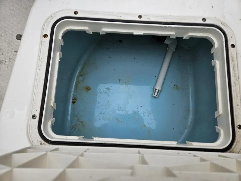 Slide: The Image of Open storage compartment on 2015 Pioneer Islander 197 boat, showing interior details. - 18