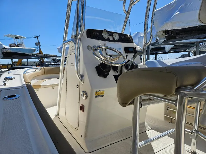 Slide: The Image of Interior view of a 2015 Pioneer Islander 197 boat, showcasing steering console and seating. - 19
