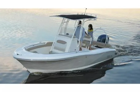Slide: The Image of 2015 Pioneer Islander 197 boat cruising on calm water, featuring a sleek design and spacious deck. - 2