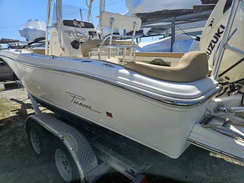 Slide: The Image of 2015 Pioneer Islander 197 boat on trailer, featuring Suzuki outboard motor. - 20