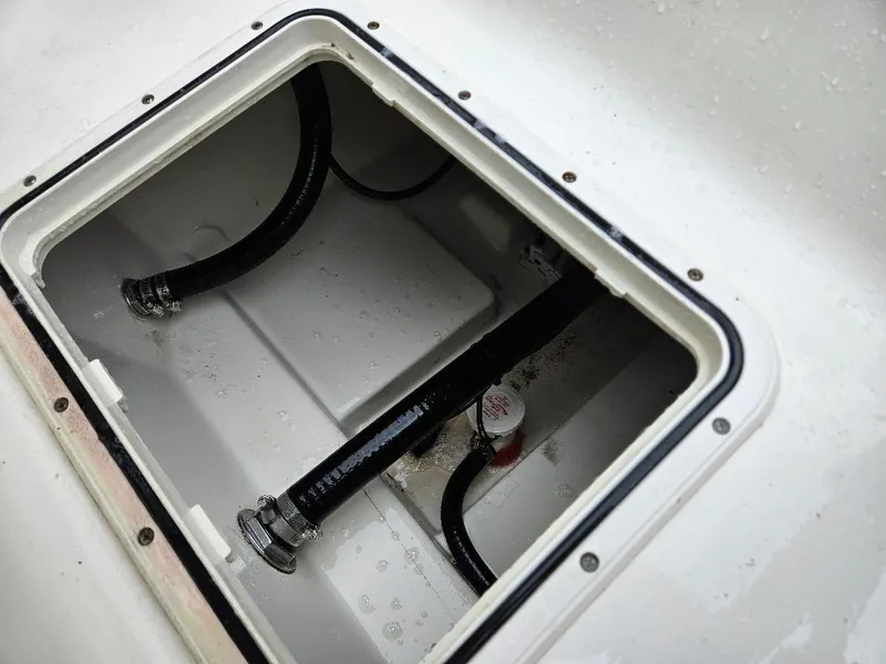Slide: The Image of Open hatch with hoses inside a 2015 Pioneer Islander 197 boat. - 8