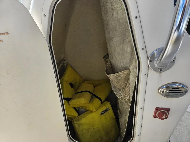 Slide: The Image of Storage compartment on a 2015 Pioneer Islander 197 boat with yellow life jackets. - 9