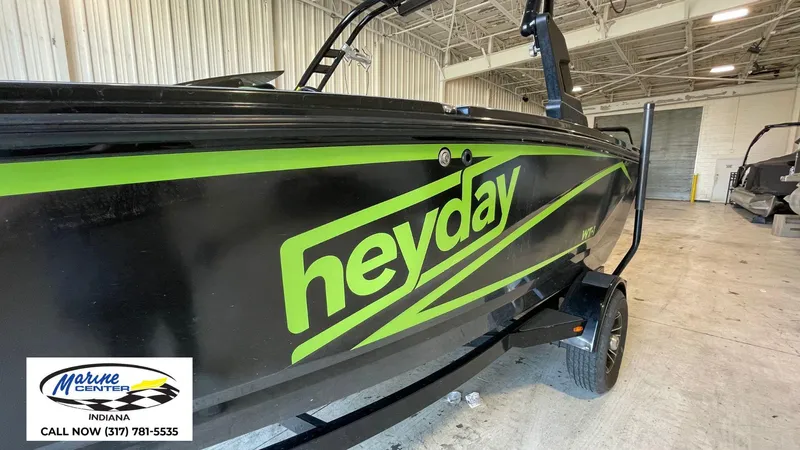 Slide: The Image of 2019 Heyday WT-1 boat in a showroom, featuring bold green and black design. - 5