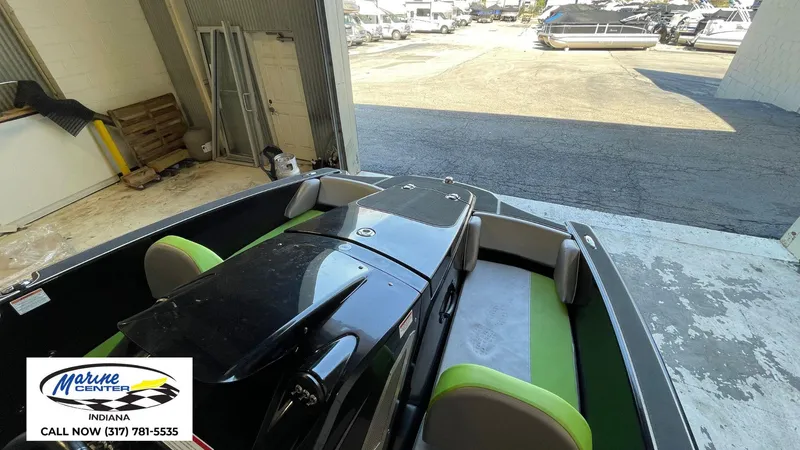 Slide: The Image of 2019 Heyday WT-1 boat in a garage, featuring green and gray seating, at Marine Center Indiana. - 8