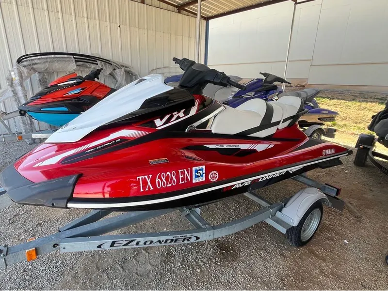 Slide: The Image of 2018 Yamaha VX Cruiser jet ski on trailer, red and white design, parked in storage. - 5