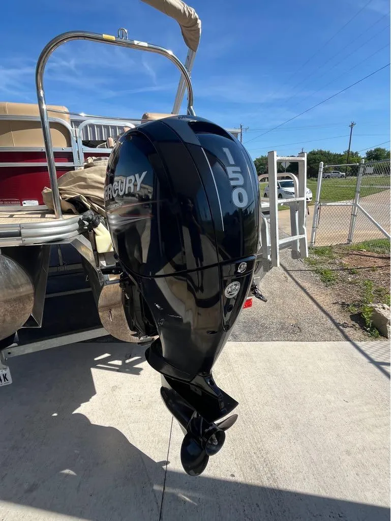 Slide: The Image of 2019 Lowe SS230W boat with Mercury 150 outboard motor, parked outdoors. - 6