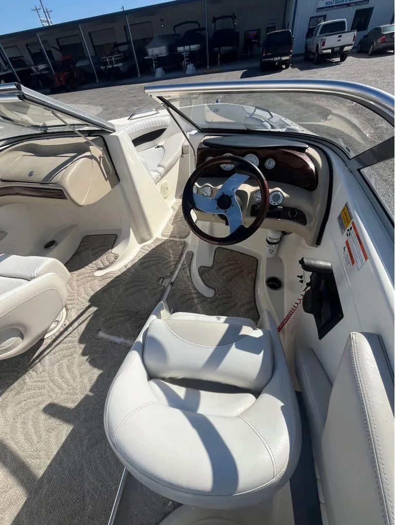 Slide: The Image of 2007 Glastron GXL235 boat interior with steering wheel and seating. - 3
