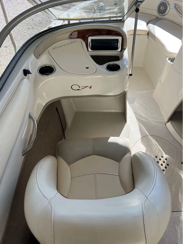 Slide: The Image of Interior of a 2009 Tahoe Q71SSF boat, featuring a white captain's chair and dashboard. - 3