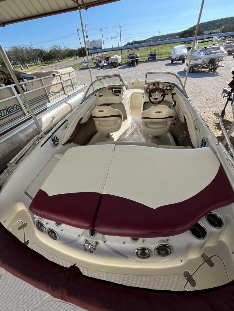 Slide: The Image of 2009 Tahoe Q71SSF boat interior with maroon and cream seating under a covered area. - 4